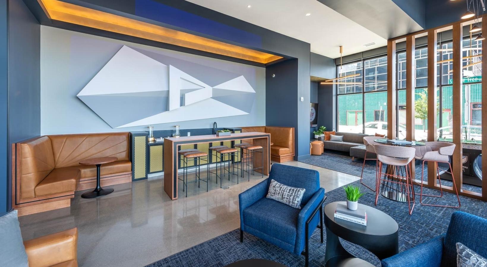 Find your perfect fit at Pivot a room with a large glass wall and a table with chairs