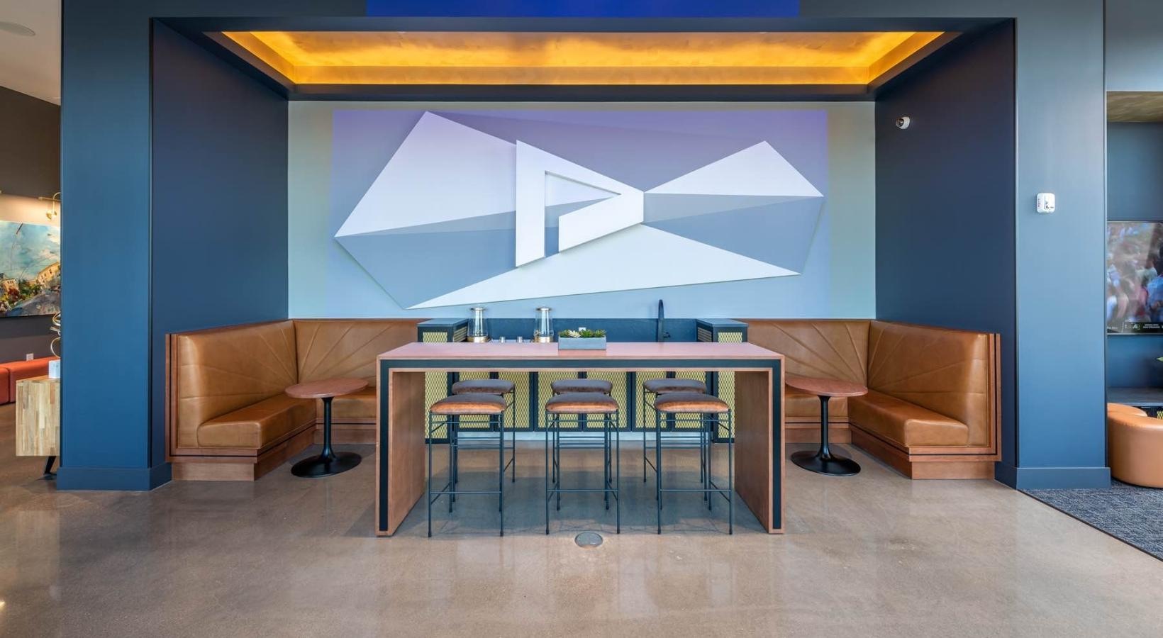 Enjoy our resident-only features a room with a table chairs and a large screen