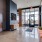 a room with a large glass door and a large glass wall with art on it