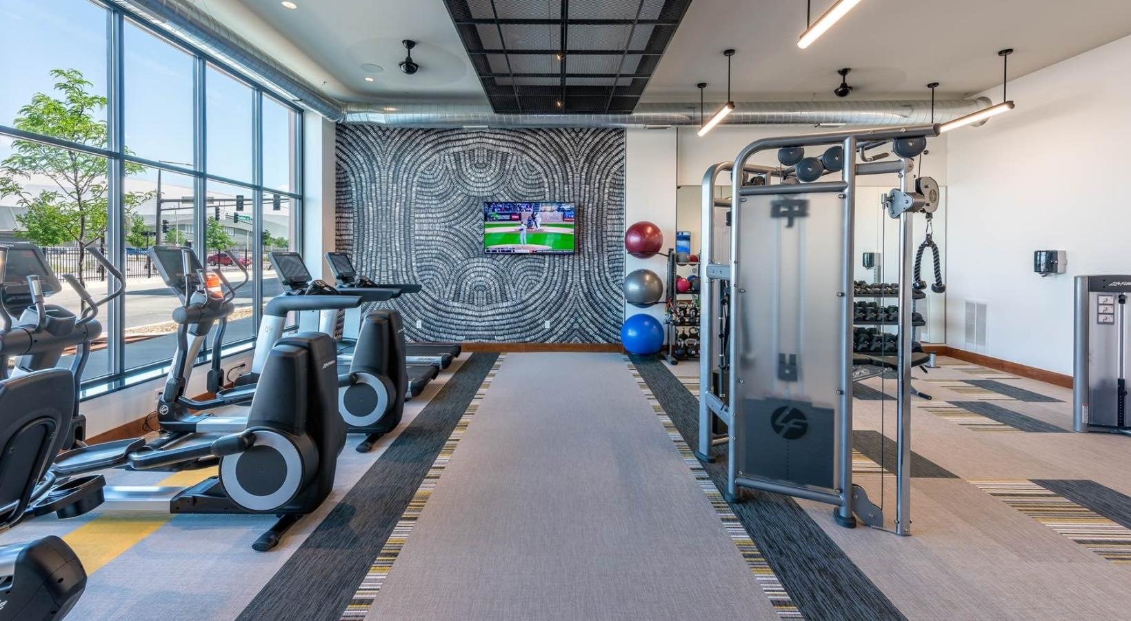 Cutting-edge amenities at your fingertips a gym with exercise equipment