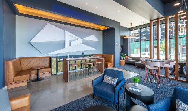 Find your perfect fit at Pivot a room with a large glass wall and a table with chairs