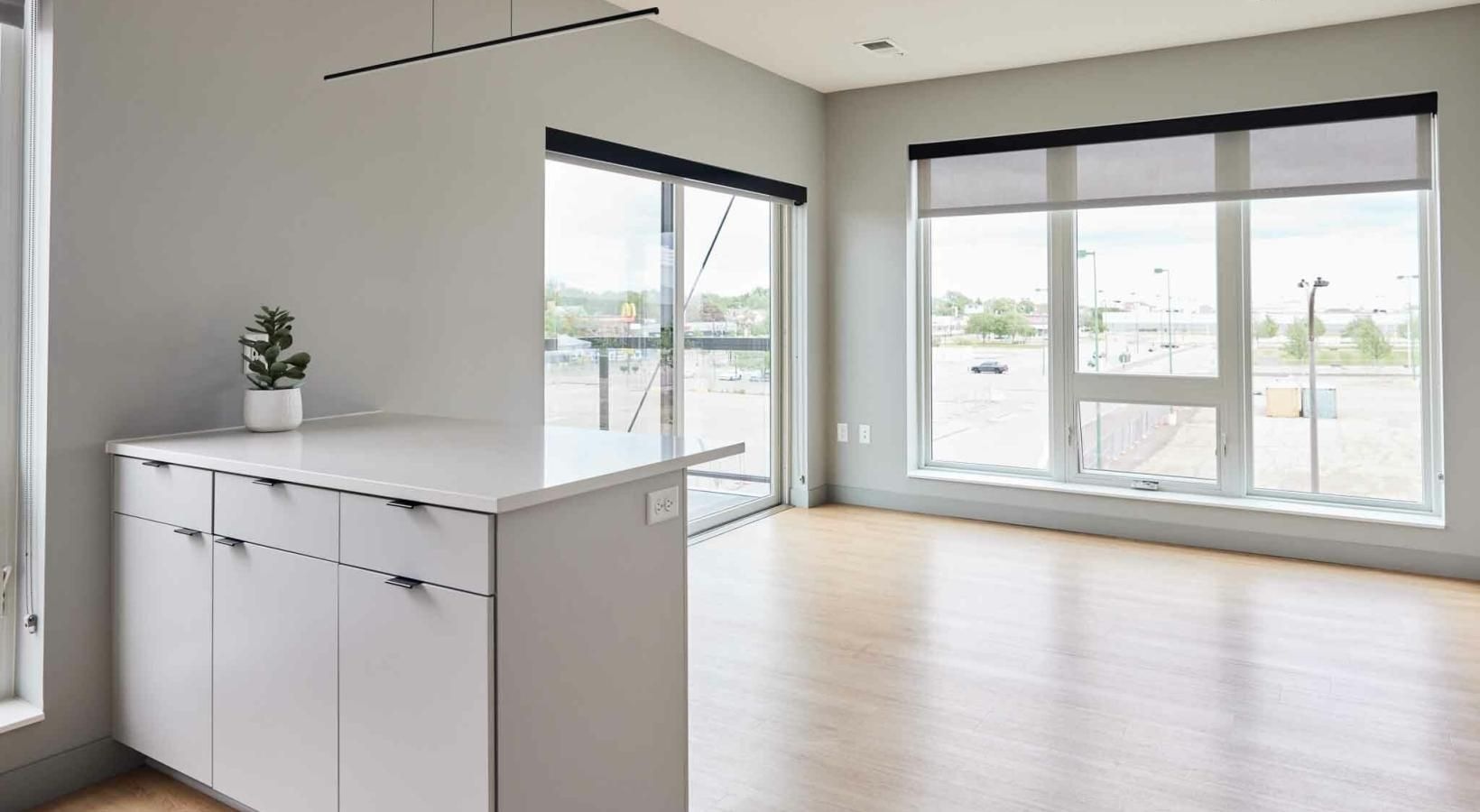 Generous living spaces with beautiful natural lighting a kitchen with white cabinets