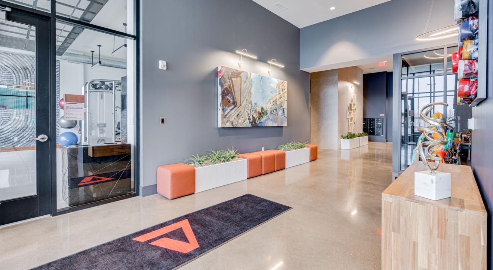 Settle into comfort at Pivot a room with a glass wall and a rug and a table