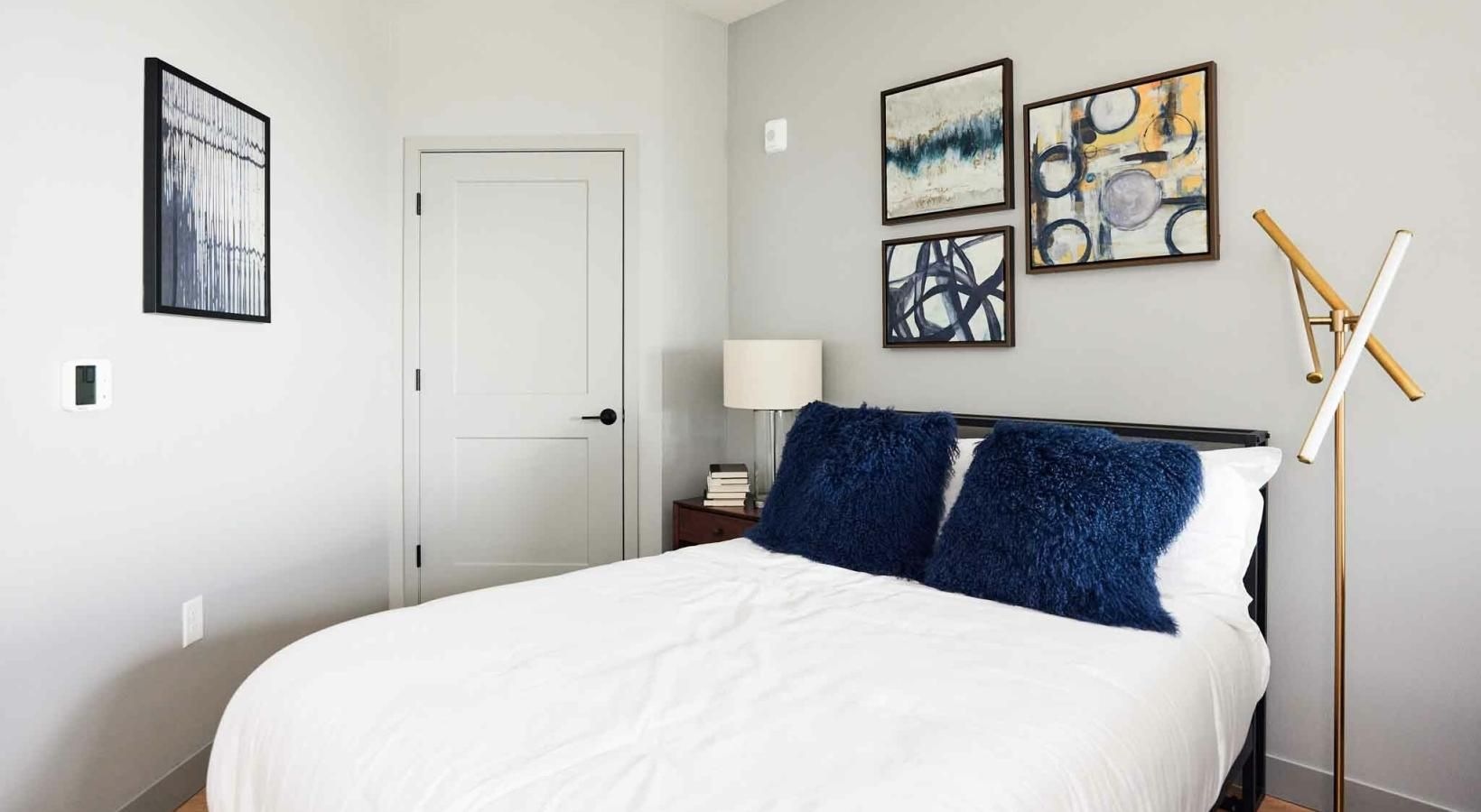 Generous bedroom offerings to fit every family a bed with blue pillows