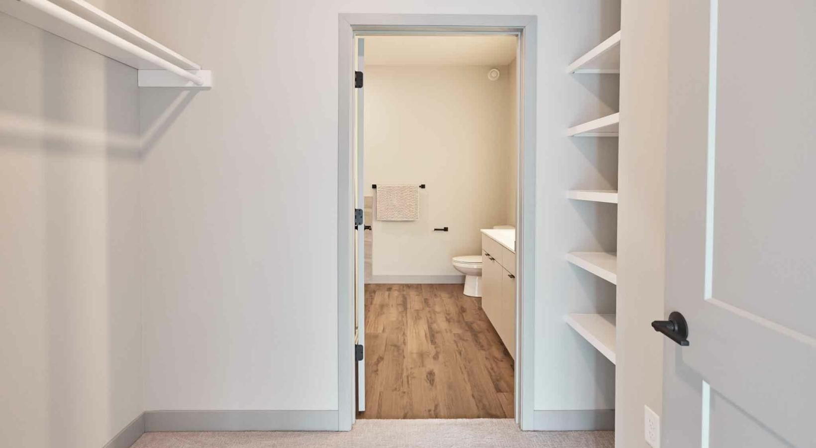 Bathroom options with thoughtful details a room with a door and shelves