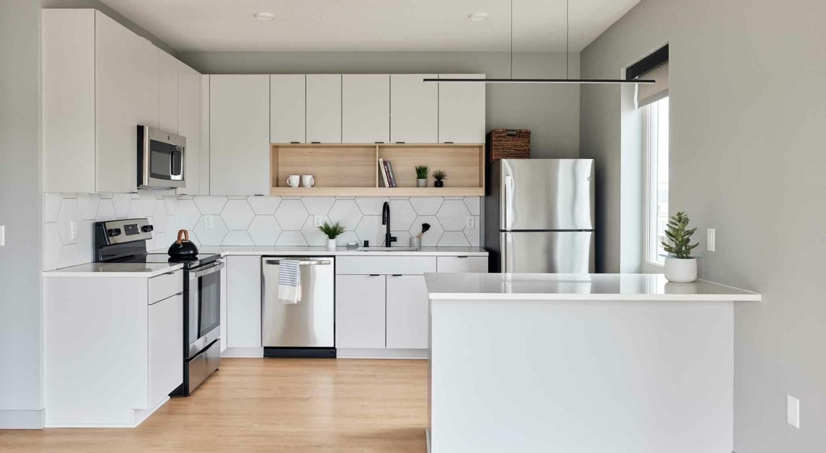Spacious kitchens with thoughtful details a kitchen with white cabinets
